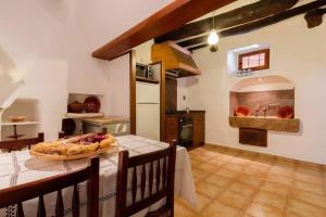a kitchen with a table with a pizza on it at Plana Morro in Pollença