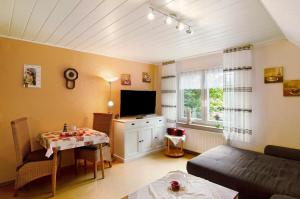 a living room with a couch and a table at Ferienhaus Gerda Wohnung 1 in Westochtersum