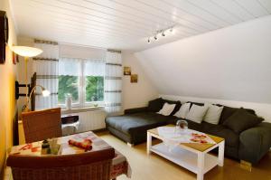 a living room with a couch and a table at Ferienhaus Gerda Wohnung 1 in Westochtersum