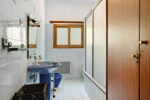 a bathroom with a blue sink and a toilet at Vermarl - Viana do Castelo in Linhares de Cima +25 photos