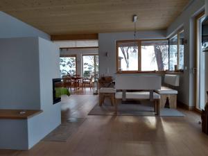 a living room with a table and a piano at Haus am Teich mit privater Sauna in Sankt Leonhard bei Freistadt +31 photos