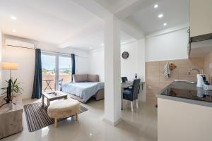 a kitchen and living room with a bed and a desk at Apartments Kankaras - Sea View in Tivat