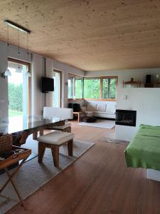 a living room with a table and a couch at Haus am Teich mit privater Sauna in Sankt Leonhard bei Freistadt
