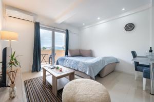 a bedroom with a bed and a table and a desk at Apartments Kankaras - Sea View in Tivat +16 photos