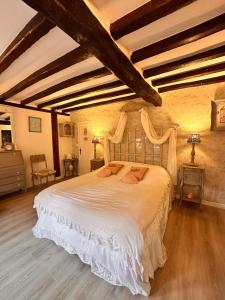 a bedroom with a large white bed in a room at Chic et Charme Cottage in Suzay +78 photos