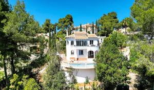 a white house on the side of a mountain at Casa Crystal in Jávea