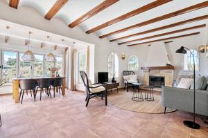 a living room with a table and chairs and a fireplace at Casa Crystal in Jávea