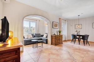 a living room with a couch and a table at Casa Crystal in Jávea