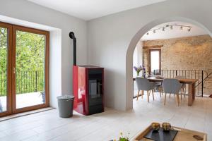 a living room with a red refrigerator and a table at Casa Rea in Murazzano +25 photos