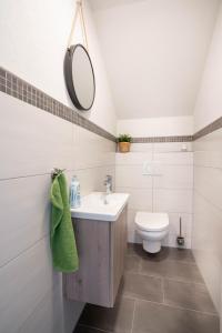 a bathroom with a sink and a toilet at Ferienwohnung Weitblick in Durbach