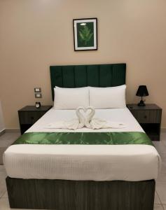 a bedroom with a bed with a bow on it at Cairo City Inn Hotel in Cairo