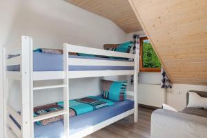 a bunk bed room with two bunk beds in a house at Ferienwohnung Sulzberg, 103qm in Alpirsbach