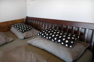 two pillows sitting on a bed in a room at Ferienhaus Ton Sünhus in Groß Labenz