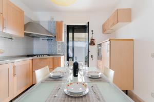 a kitchen with a table with plates and glasses on it at Casa Idrusa a Otranto in Otranto