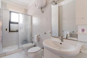 a white bathroom with a toilet and a sink at Casa Idrusa a Otranto in Otranto +20 photos