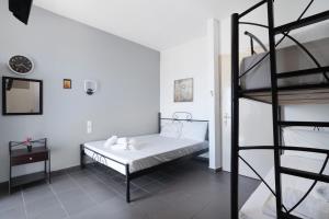 a bedroom with a bunk bed and a ladder at Iguana studio 13 in Preveza