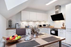 a kitchen with a table with a bowl of fruit on it at Fewo Kessler Waldblick in Häusern