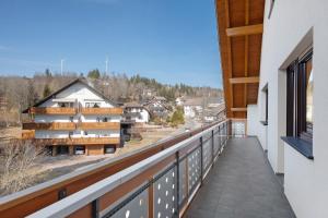 a balcony with a view of a building at Fewo Kessler Waldblick in Häusern