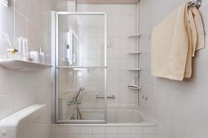 a shower with a glass door in a bathroom at Fewo Kessler Waldblick in Häusern +23 photos