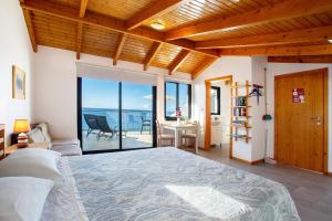 a bedroom with a bed and a view of the ocean at The Wave House - Oceanfront in Jardim do Mar