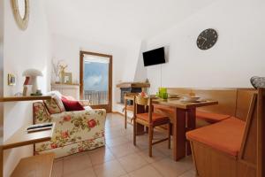 a living room with a couch and a table at La finestra sui monti - Breguzzo in Breguzzo