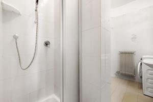 a white bathroom with a shower and a toilet at La finestra sui monti - Breguzzo in Breguzzo +16 photos