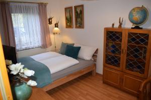 a small bedroom with a bed and a window at Landhaus Eva-maria in Elbingerode