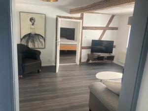 a living room with a couch and a television at Charmante Ferienwohnung im Gässchen in Rudolstadt