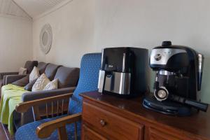 a coffee maker sitting on top of a wooden dresser at Quinta Natureza de Coura in Paredes de Coura