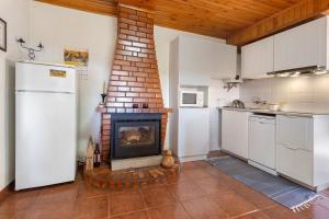 a kitchen with a fireplace in the middle of a room at Quinta Natureza de Coura in Paredes de Coura