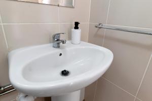a white sink in a bathroom with a mirror at Quinta Natureza de Coura in Paredes de Coura +27 photos