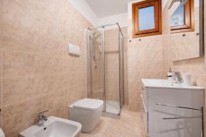 a bathroom with a shower and a toilet and a sink at vista lago apartment 1 in Soiano del Lago +16 photos