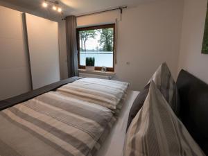 a bedroom with a bed and a window at Hof Weuste Fewo Lister in Attendorn