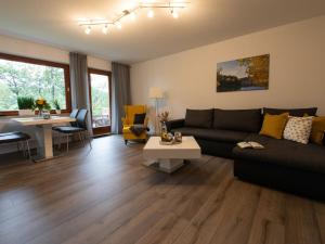 a living room with a couch and a table at Hof Weuste Fewo Lister in Attendorn