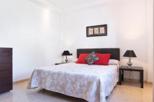 a bedroom with a bed with red pillows on it at Villa Eris in Puerto del Carmen +12 photos