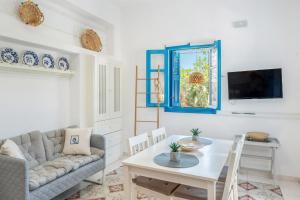 a living room with a couch and a table at Avlona Blue in Diafani