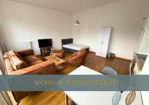 a living room with a couch and a table at Flexi Flats in Lingen