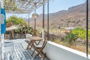 a table and chairs on a balcony with a view at Avlona Blue in Diafani