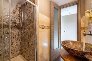 a bathroom with a vessel sink and a shower at Casa a schiera Budoni in Budoni