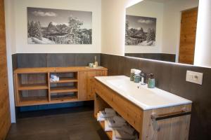 a bathroom with a sink and a mirror at Apt Lara Siela in Ortisei +20 photos