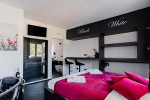 a bedroom with a large bed with a red blanket at Suite Black and White in Otranto
