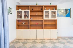 a room with a white and wooden book shelf at Villetta Stella in Chia