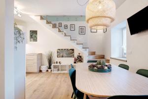 a dining room with a table and a staircase at Wellness Lodge Chicca in Santa Giuliana