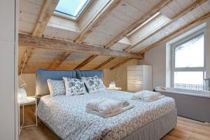 a bedroom with a bed with two pillows on it at Wellness Lodge Chicca in Santa Giuliana