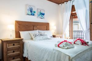 a bedroom with a bed with two towels on it at La Plazuela I in Pereña