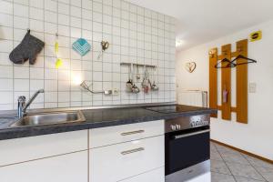 a kitchen with a sink and a stove at Schwarzwald Buchenhof in Zell am Harmersbach +74 photos
