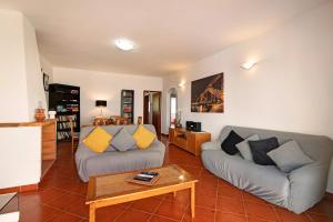 a living room with two couches and a coffee table at Villa Isabel in Loulé
