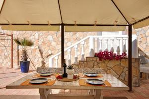 a table under an umbrella on a patio at Villa Isabel in Loulé