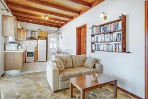 a living room with a couch and a table at Villa Jimmy's Katomeri 3 in Meganisi