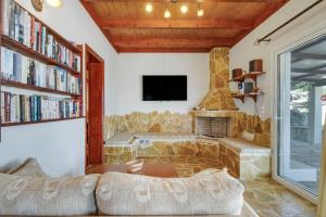 a living room with a couch and a fireplace at Villa Jimmy's Katomeri 3 in Meganisi